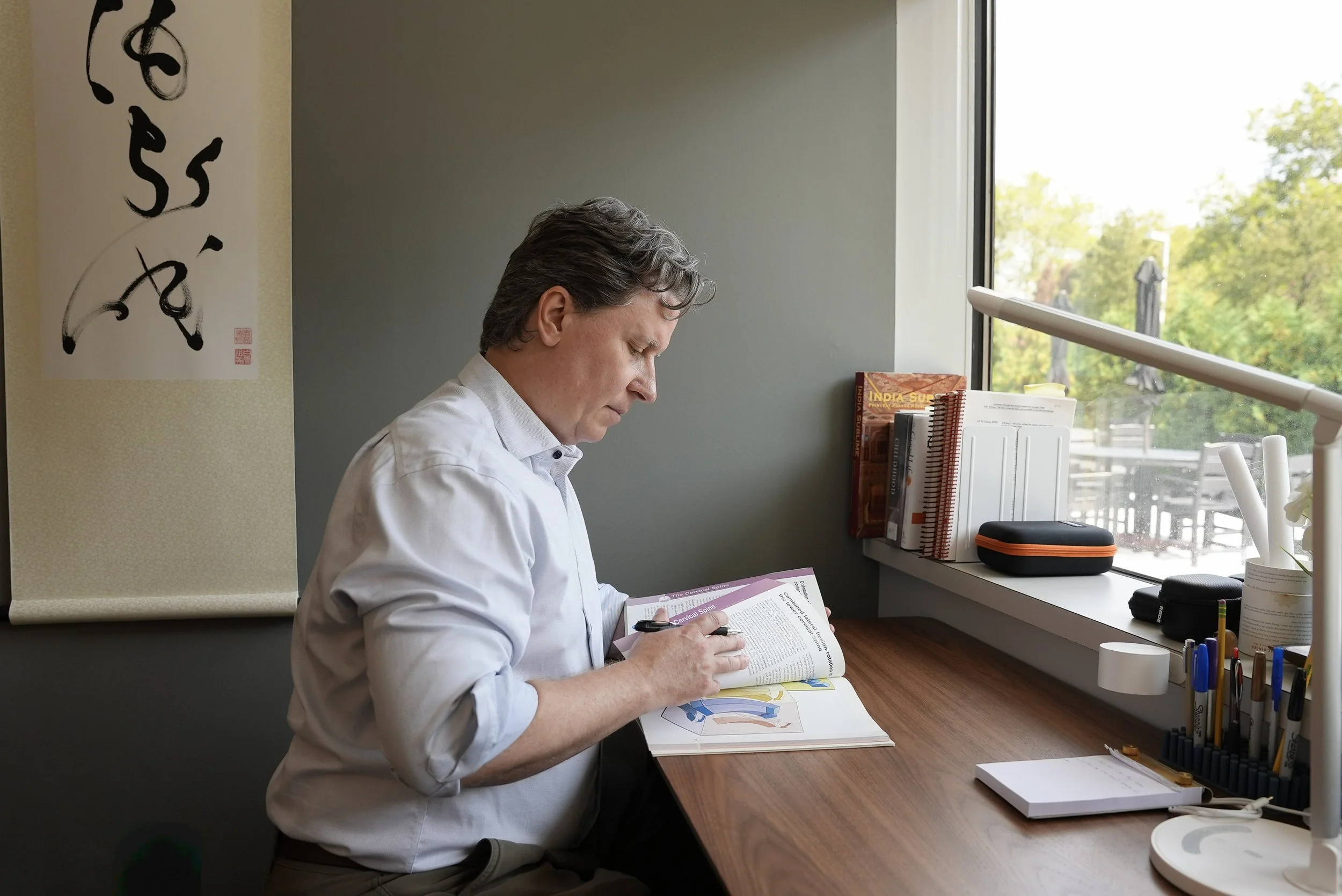 Andrew Gibbons studying joint function at Body of Knowledge's Long Island Office. 