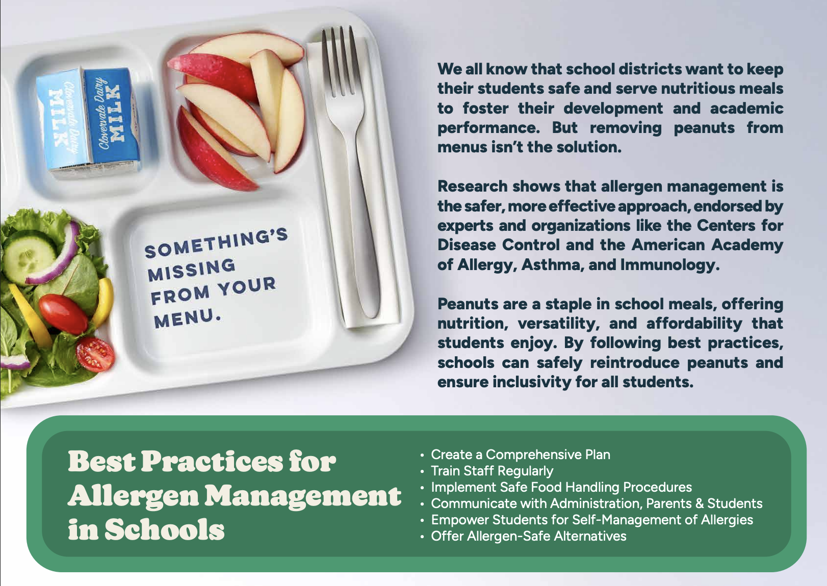A school lunch tray containing apple slices, a carton of milk, and a small salad with lettuce, cherry tomatoes, cucumber slices, and yellow bell pepper strips. Next to the tray are disposable utensils, a fork and a knife. The tray has a message that 