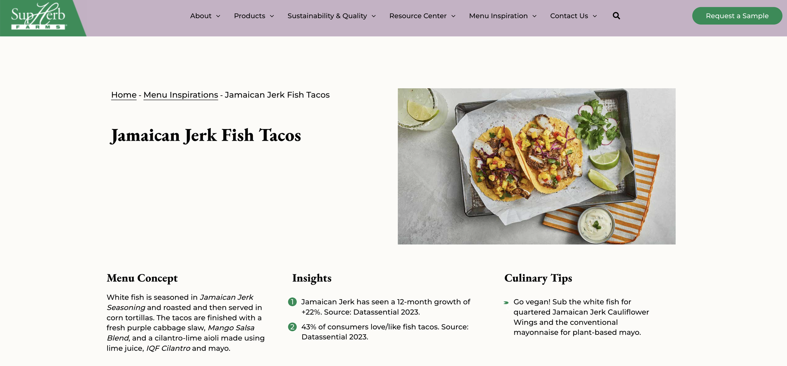 Photo of Jamaica jerk fish tacos served on a tray with lime wedges, cilantro, and a side of sauce on a table.