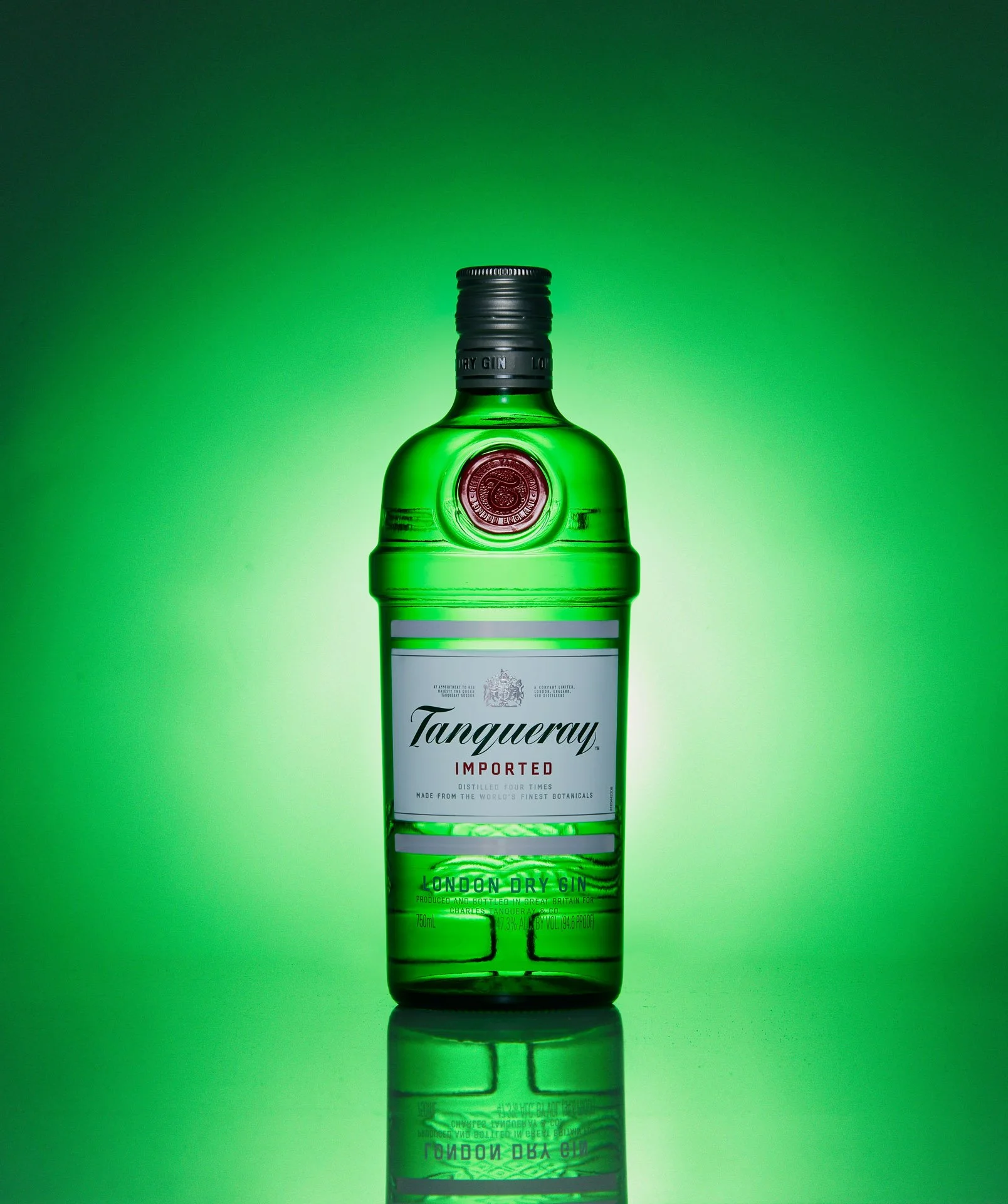 Tanqueray gin bottle on green background