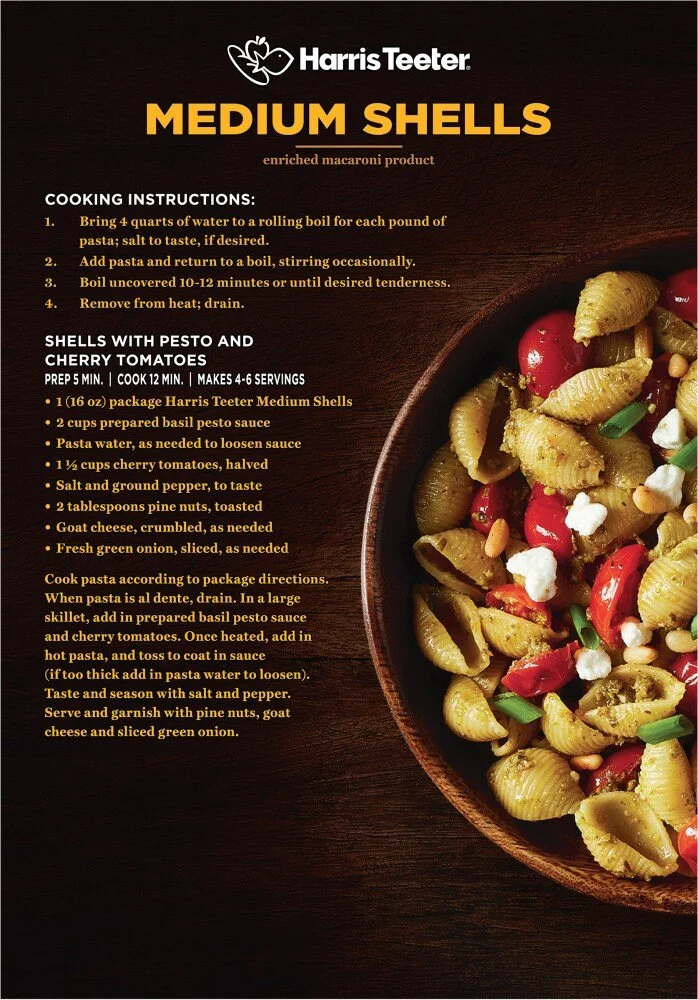 Recipe card for Harris Teeter Medium Shells pasta with pesto and cherry tomatoes, featuring cooking instructions and ingredients, with a photo of cooked pasta in a bowl garnished with green onion, pine nuts, goat cheese, and cherry tomatoes.