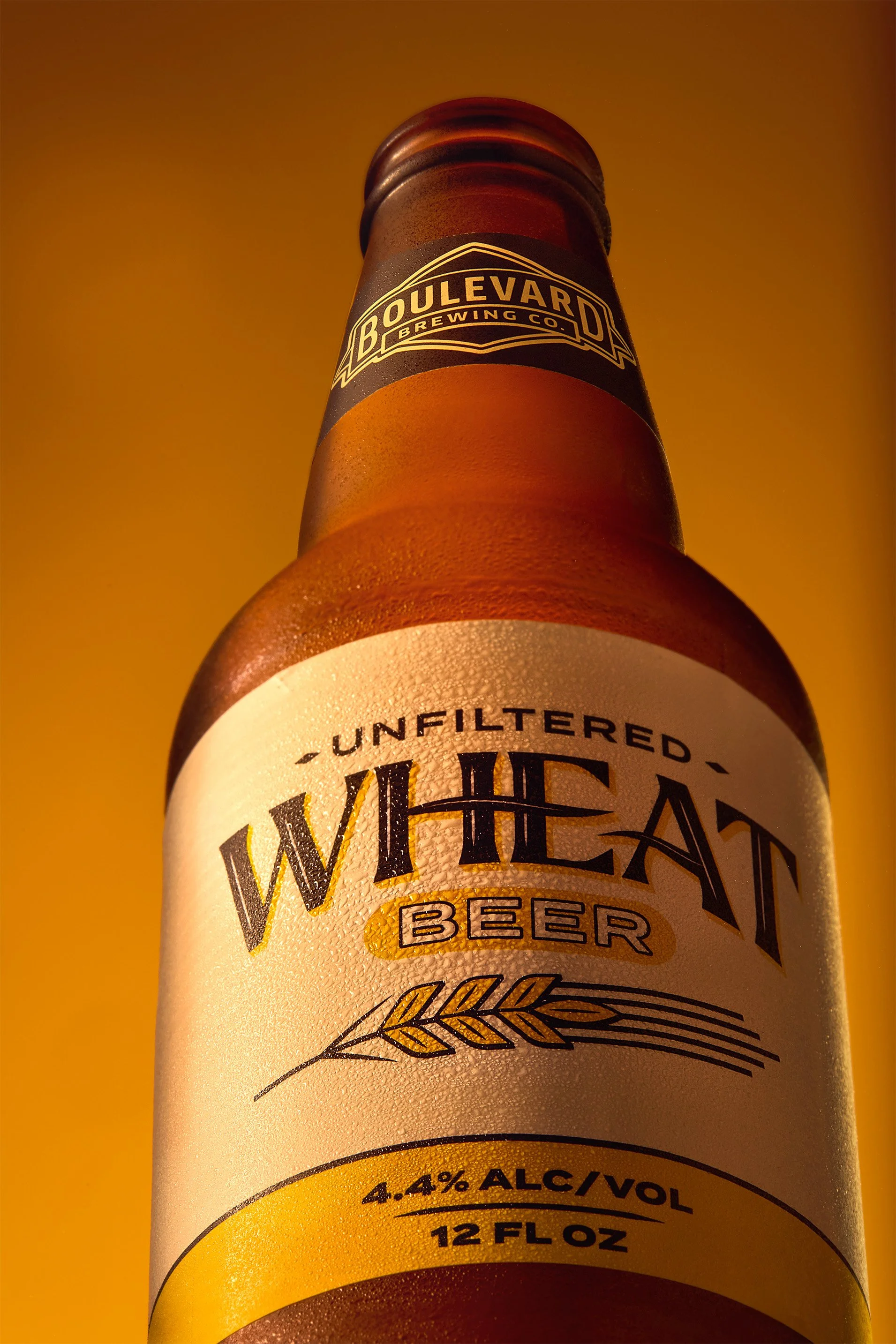 Close-up of a beer bottle label from Boulevard Brewing Co., featuring the beer name 'White Beer' and indicating it is unfiltered with 4.4% alcohol, 12 fluid ounces.
