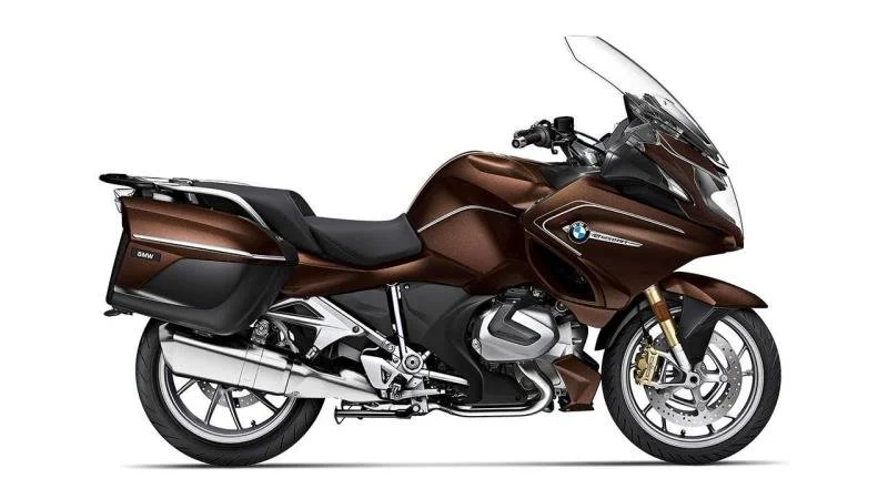 Bronze BMW touring motorcycle with side panniers and a large windshield