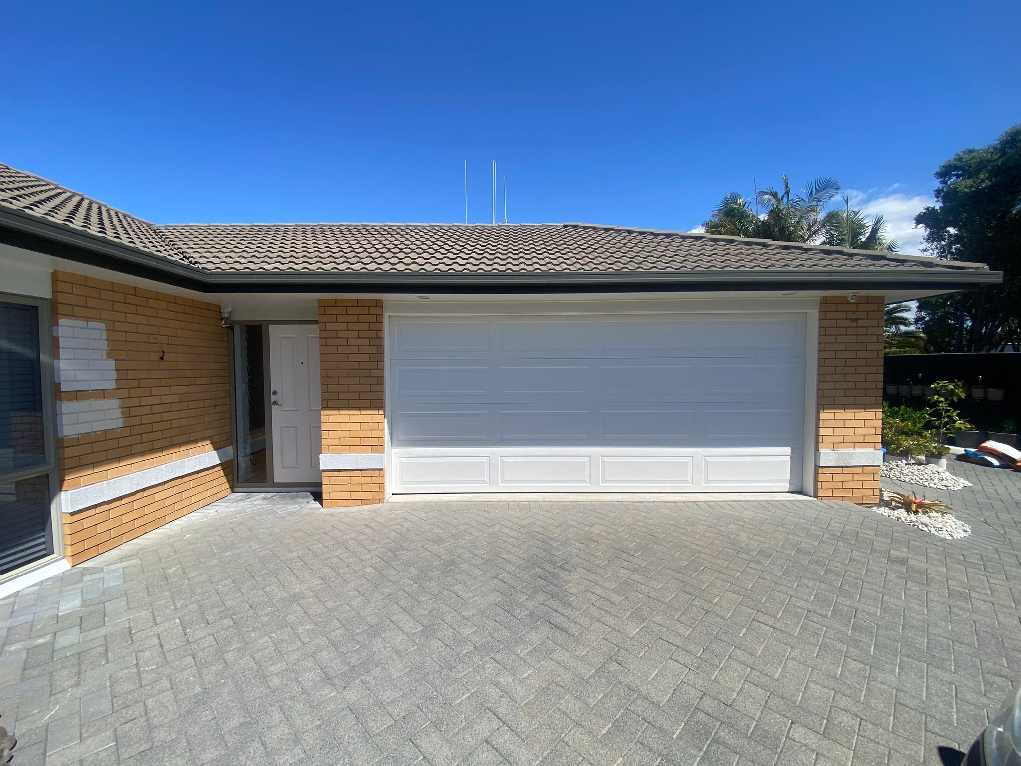 Residential home in Papamoa, Tauranga, before renovation, with a rough brick wall in need of plastering and painting to transform the outdated look into a fresh, modern design.