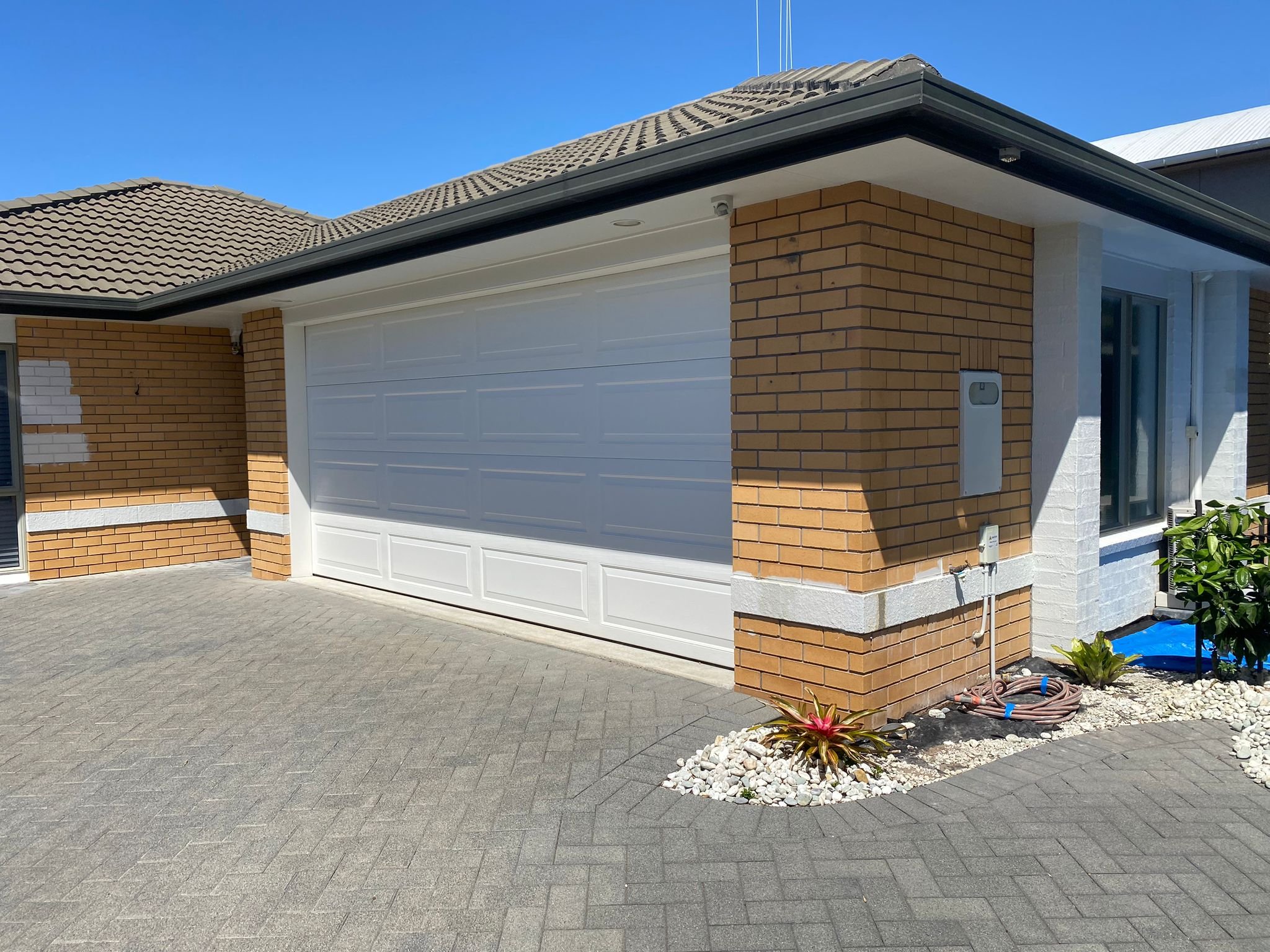 Before renovation of a residential property in Papamoa, Tauranga, featuring an old brick wall and worn exterior. This home required plastering and painting to update its appearance and give it a sleek finish