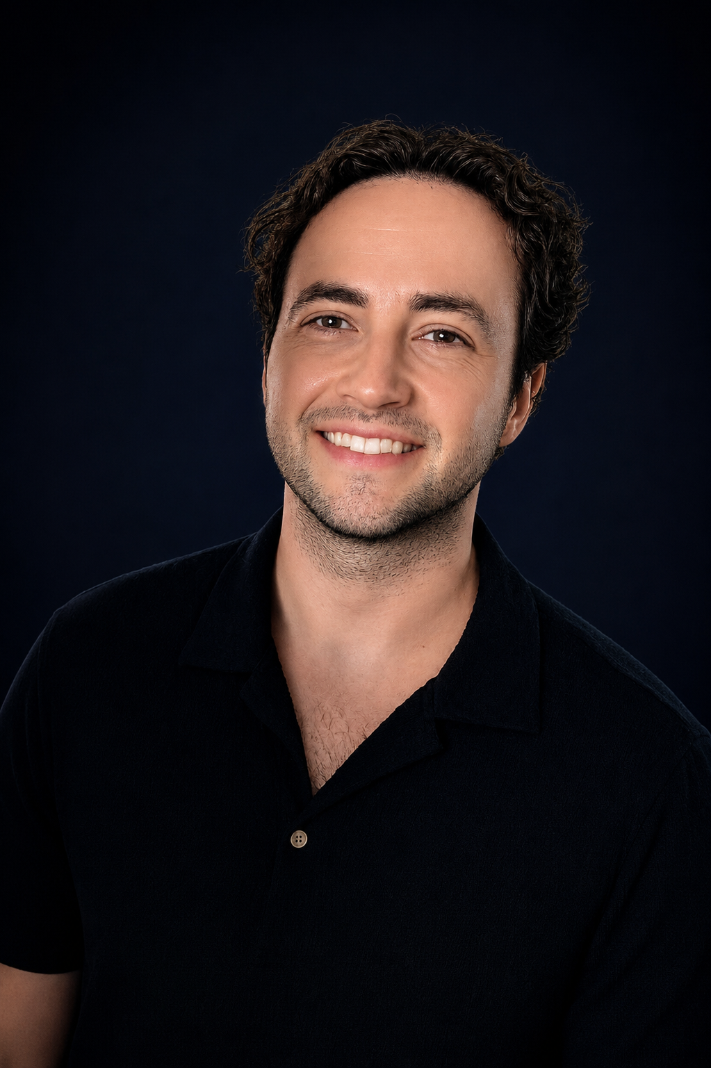Austin Schumacher, REALTOR®, standing outdoors in a dark suit