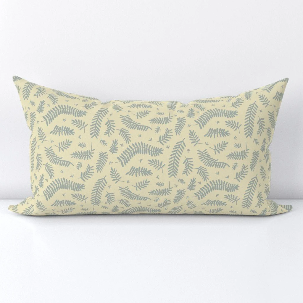 A scatter inspired by acacia leaves on soft yellow.