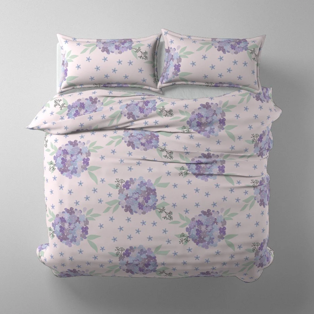 Duvet Cover - Hydrangea blossoms in lavender hues with wisps of eucalyptus leaves and tiny bluish flowers on a pale pink background.