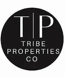 Logo of Tribe Properties Co with a black circular background and white text.