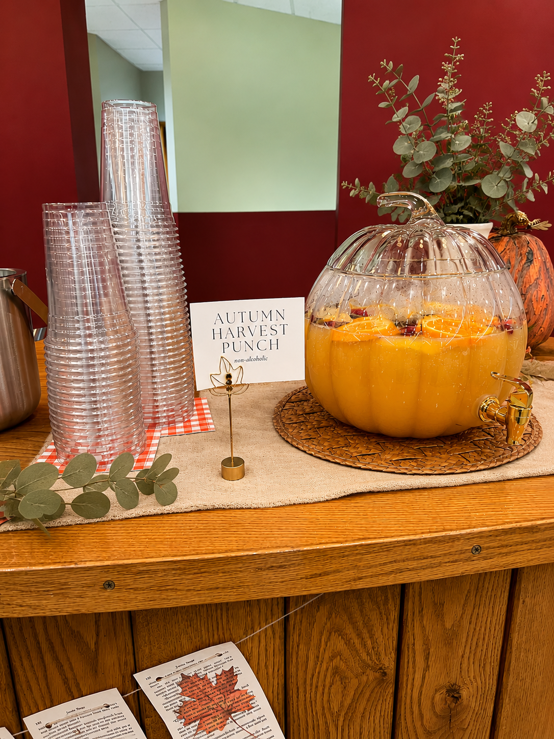 Autumn punch set up in a glass pumpkin dispenser