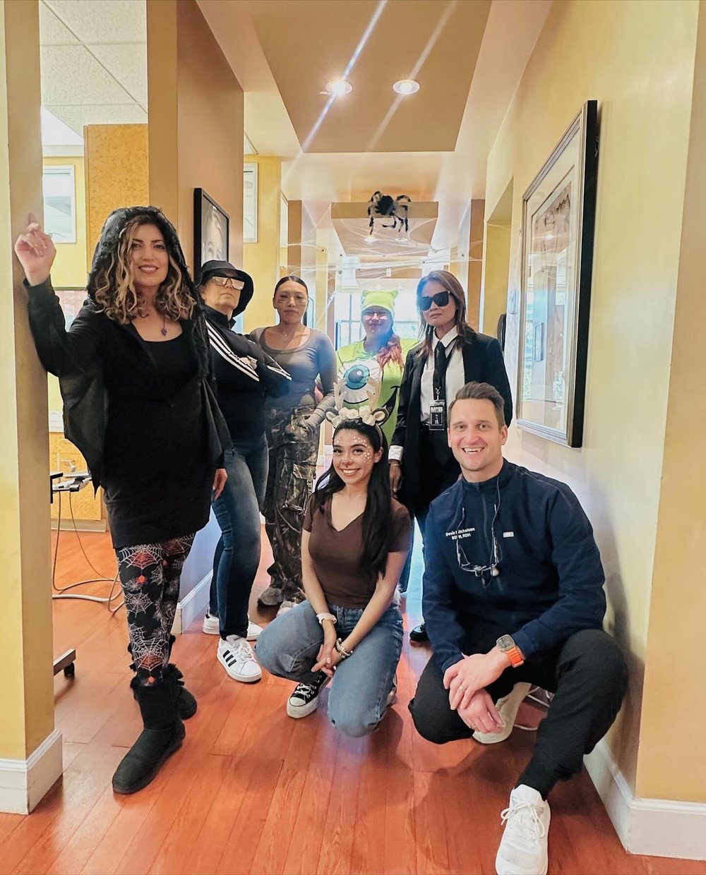 Sand Canyon Dental team members in costumes celebrating together in the office hallway