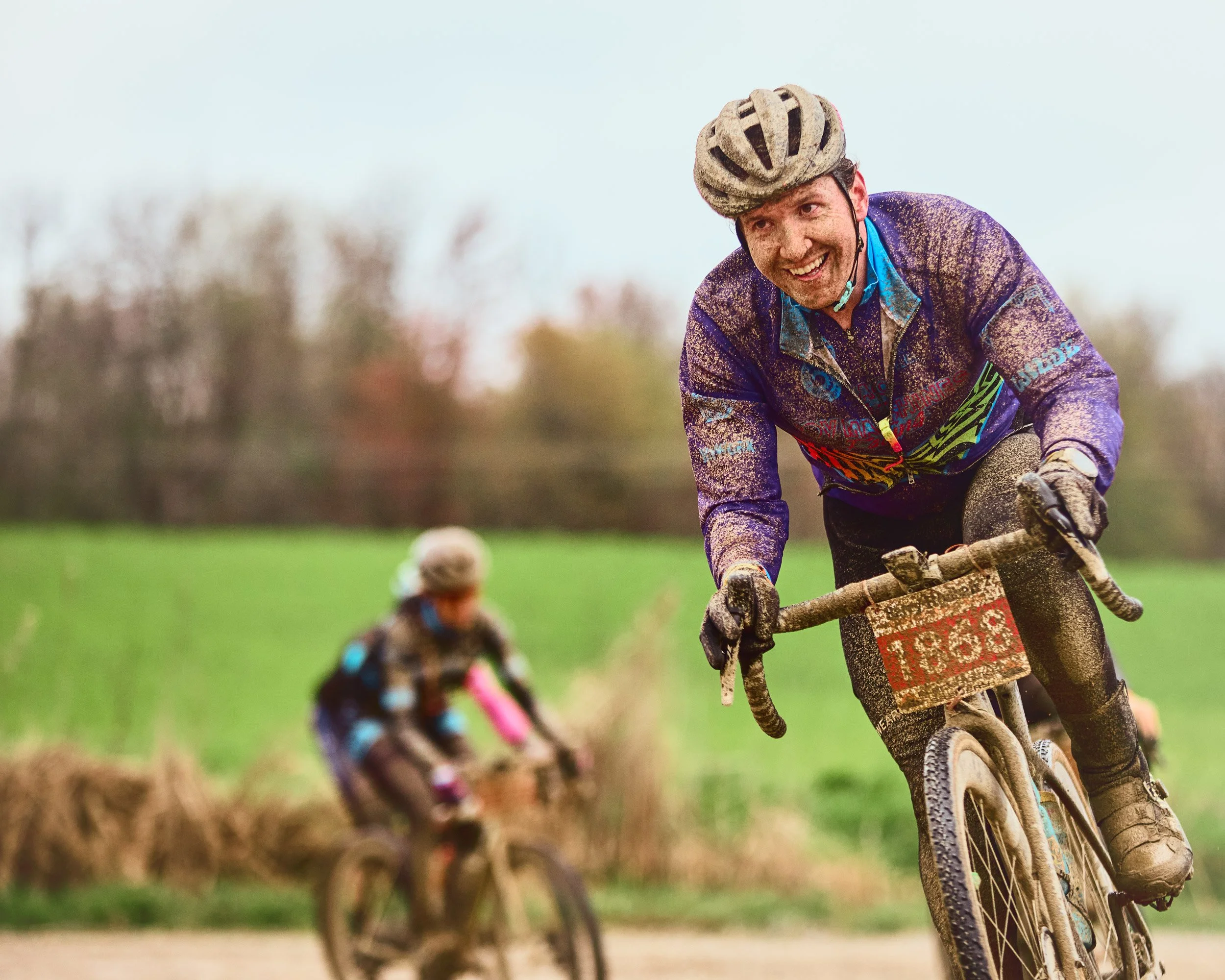 Smiling muddy cyclist Barry Roubaix 2026, Hastings Michigan, gravel cycling photography