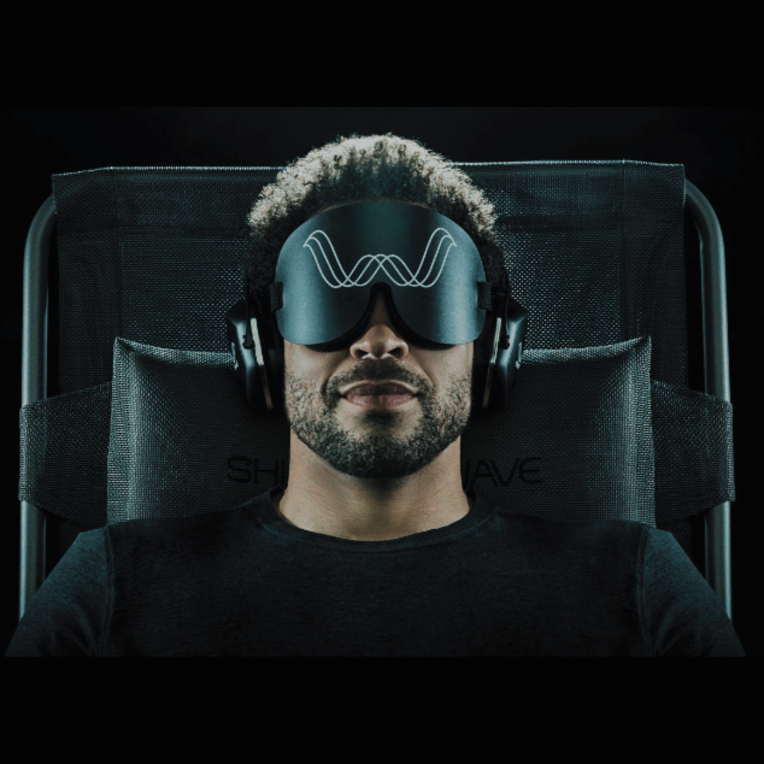 A guest at Inner Space wellness center is wearing an eye mask and headphones on the Shiftwave chair, a pulsed-pressure wellness device offered in Des Moines, Iowa.
