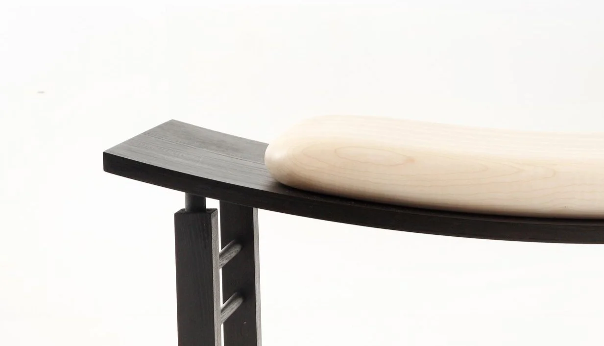Curved bench seat in ebonised ash with rippled sycamore cushion