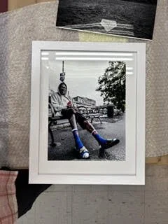 man with blue & orange socks on bench.jpg
