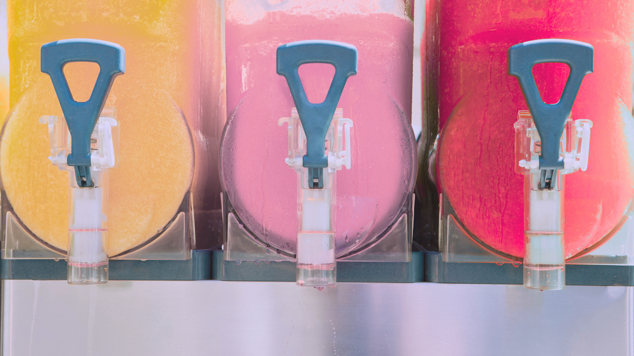 Bottles of champagne and rosé wine chilling in an ice-filled cooler.