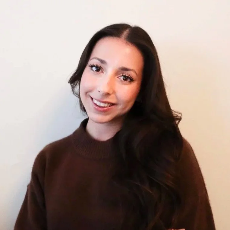 Young female with long dark brown hair and a maroon sweater.