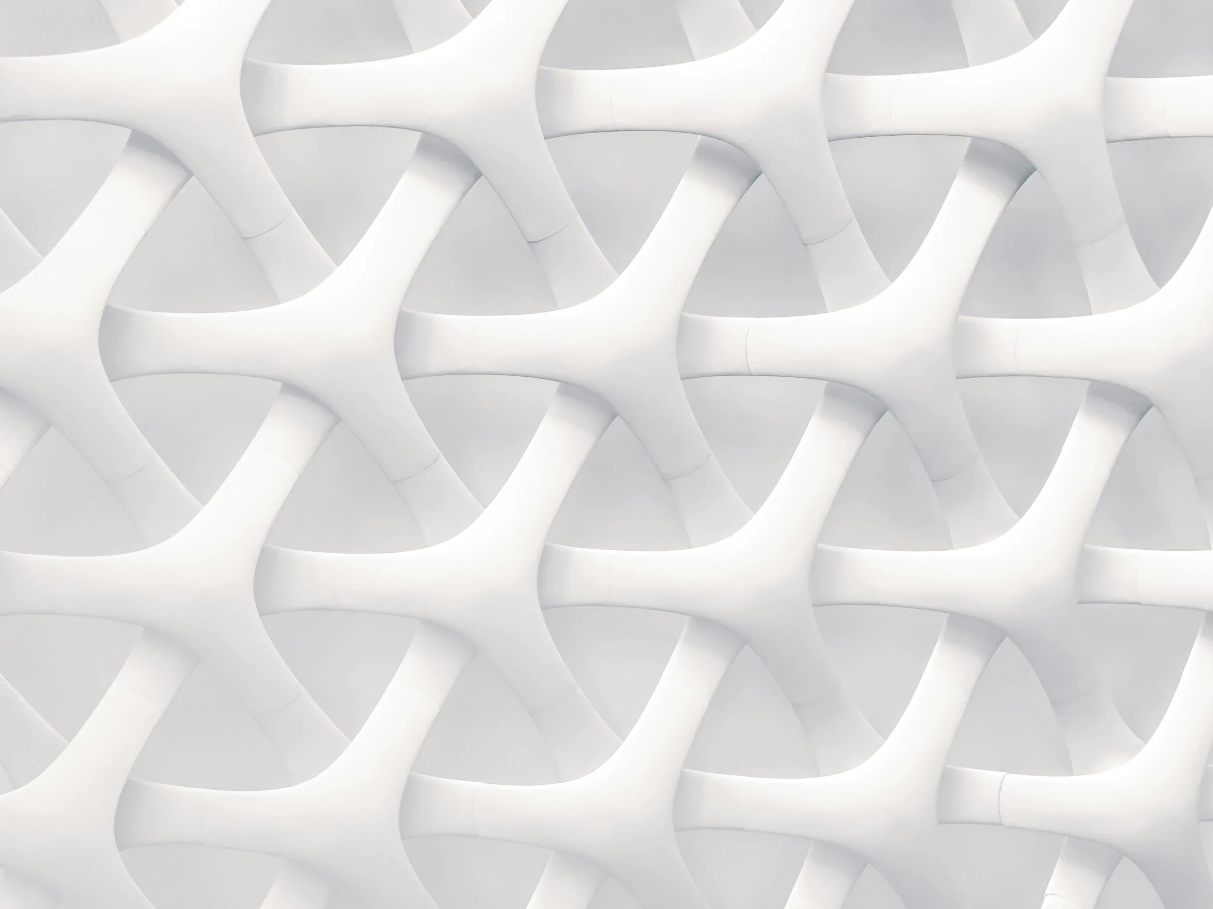 Close-up of a modern architectural white facade with interlocking curved shapes.