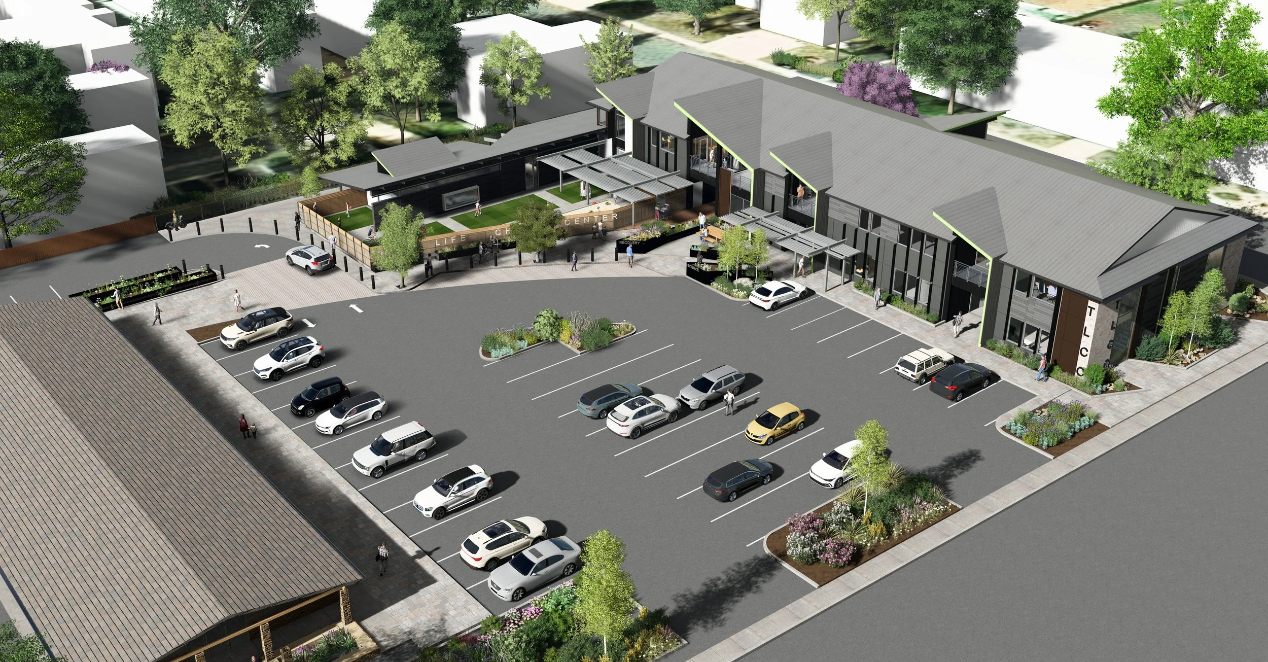 A modern building with a large parking lot and surrounding greenery