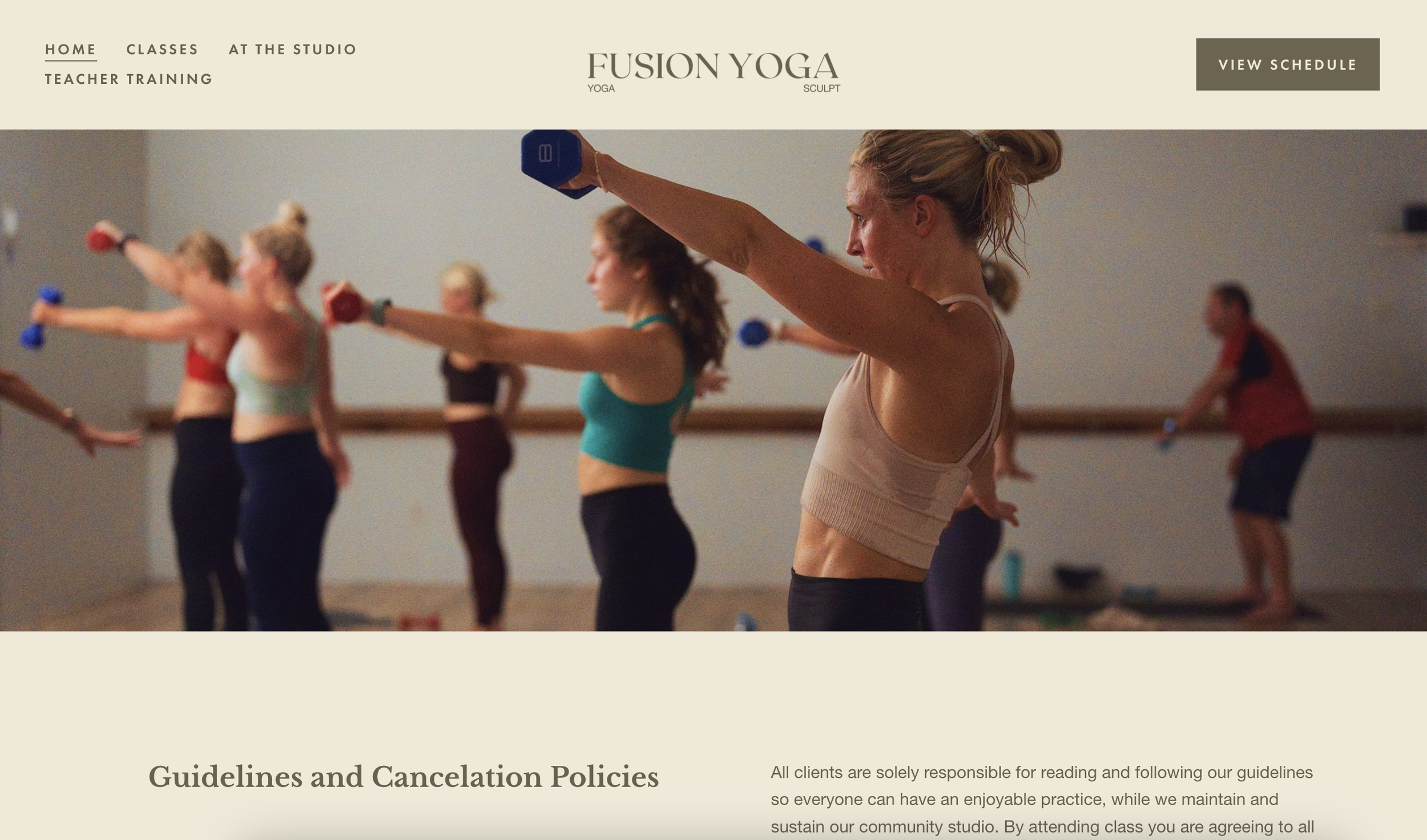 Women participating in a yoga class, holding weights in a yoga studio.