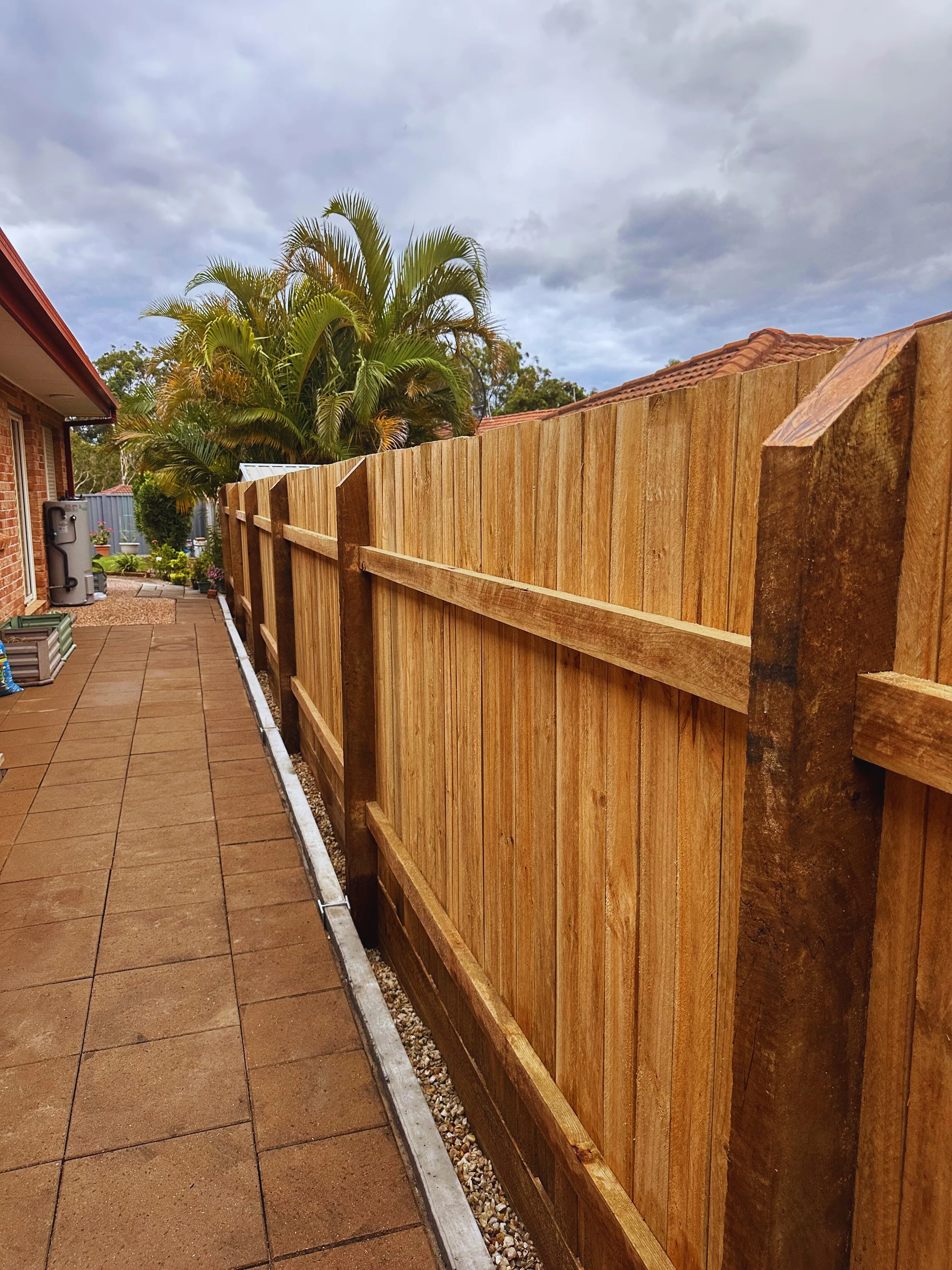 Modern pavedDriveway paving installation in Coomera Gold Coast patio with natural stone tiles in backyard