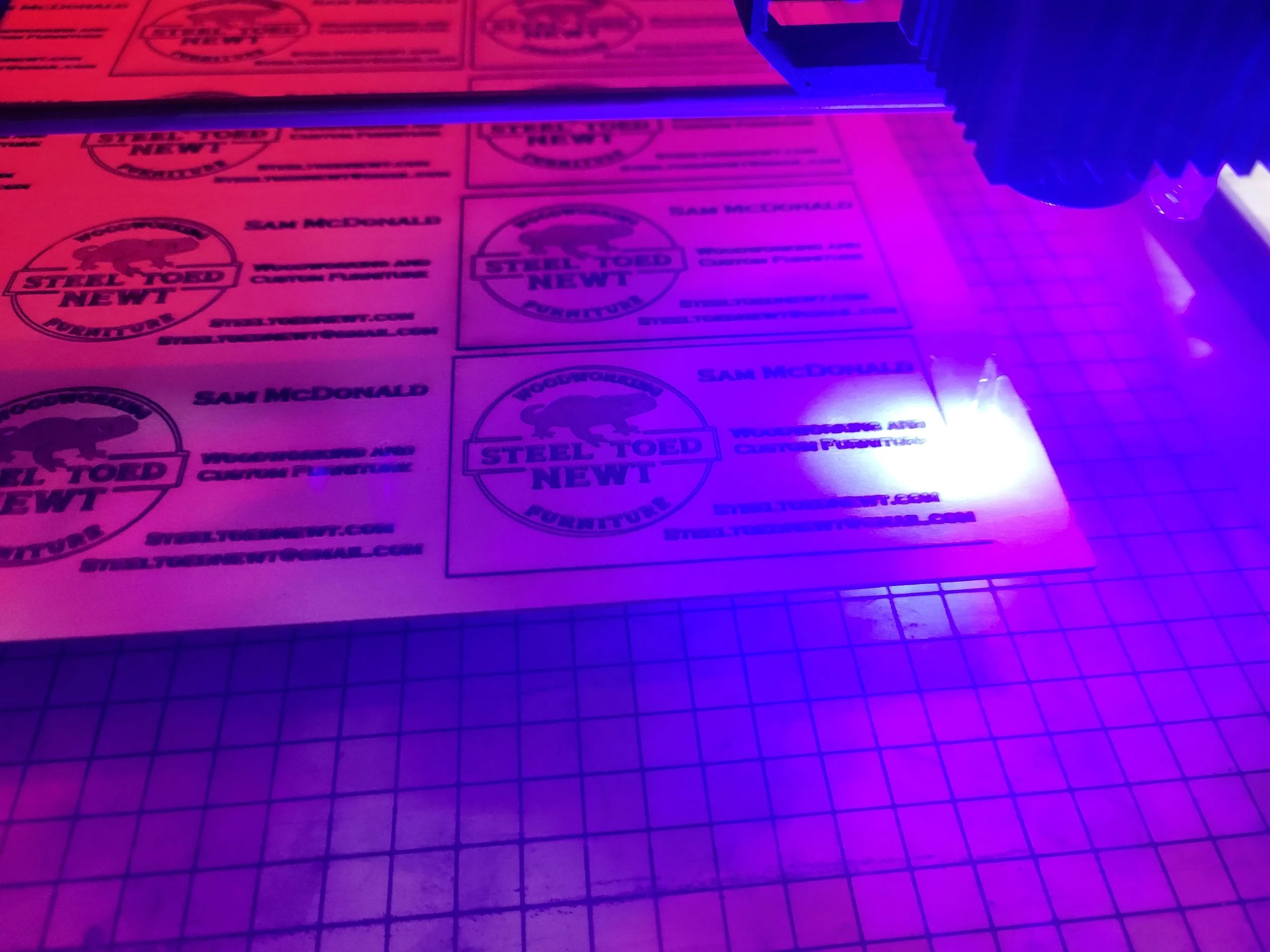 Laser engraving Steel Toed Newt business cards showing logo name website and email