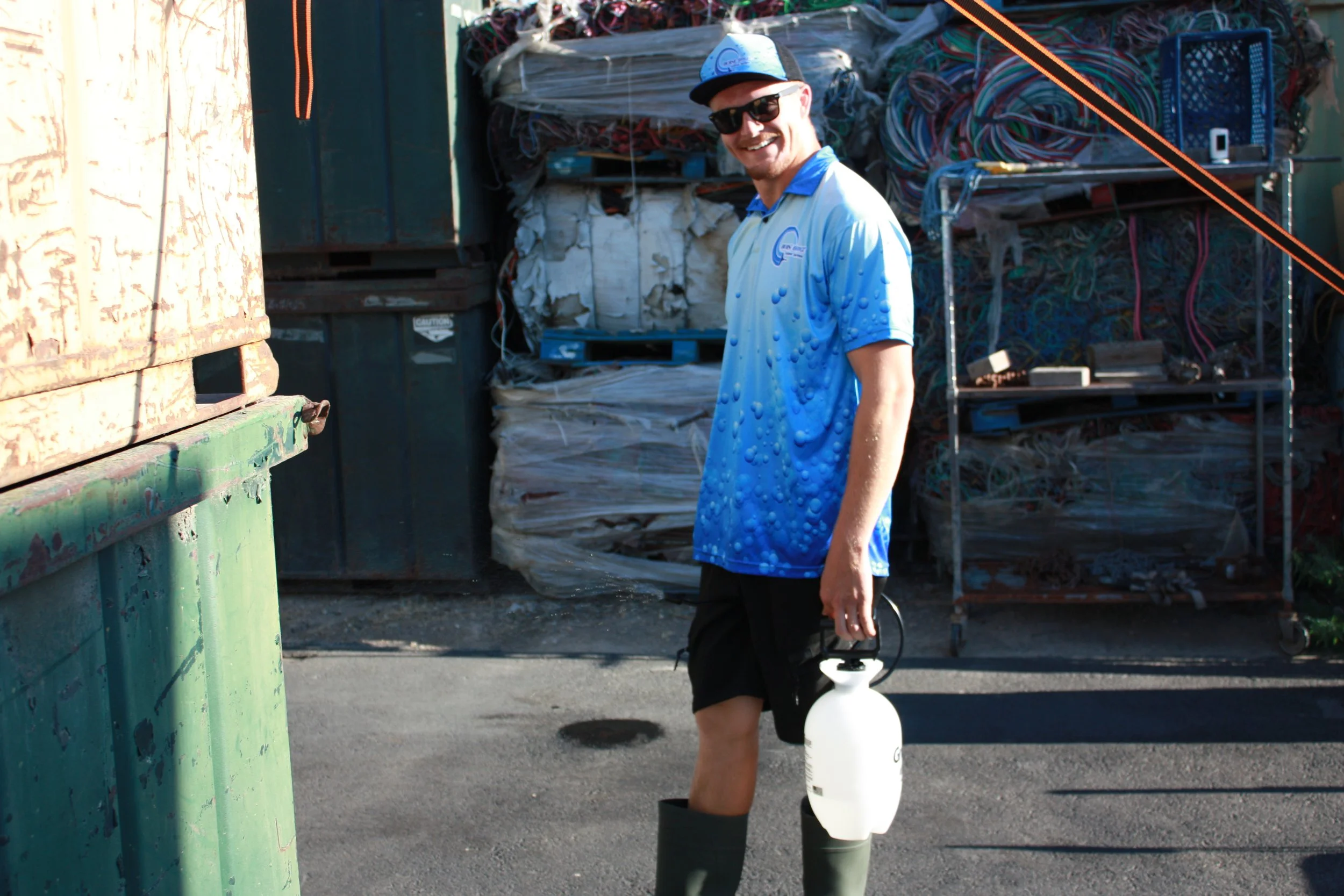 Smiling because you just watched a rust stain disappear in a matter of seconds, before pressure washing for a clean result.