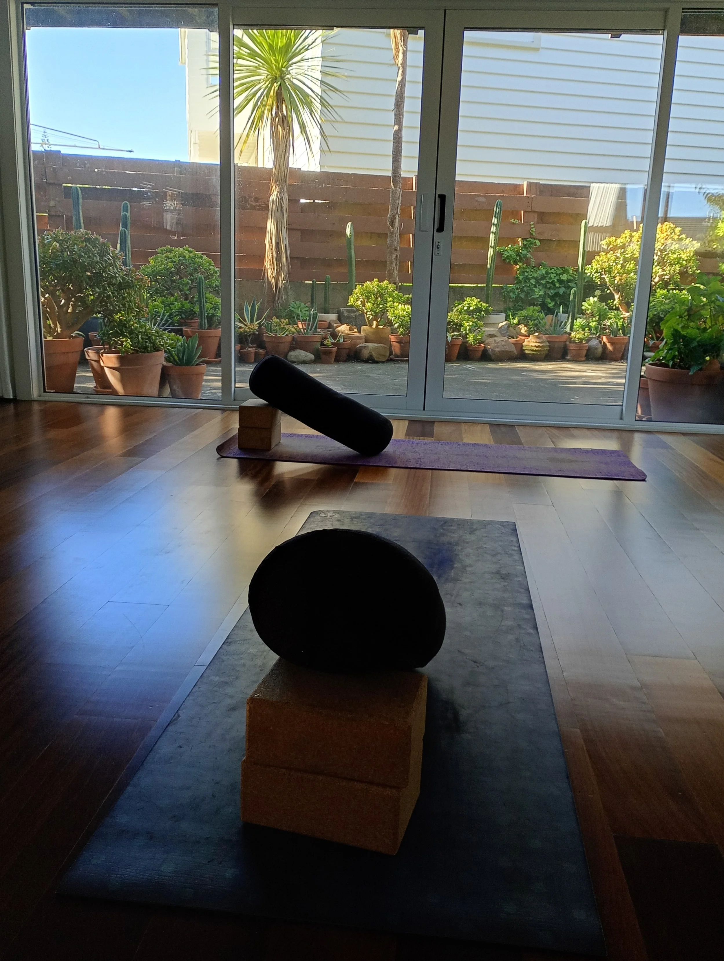 Yoga mats and bolsters in a yoga studio.