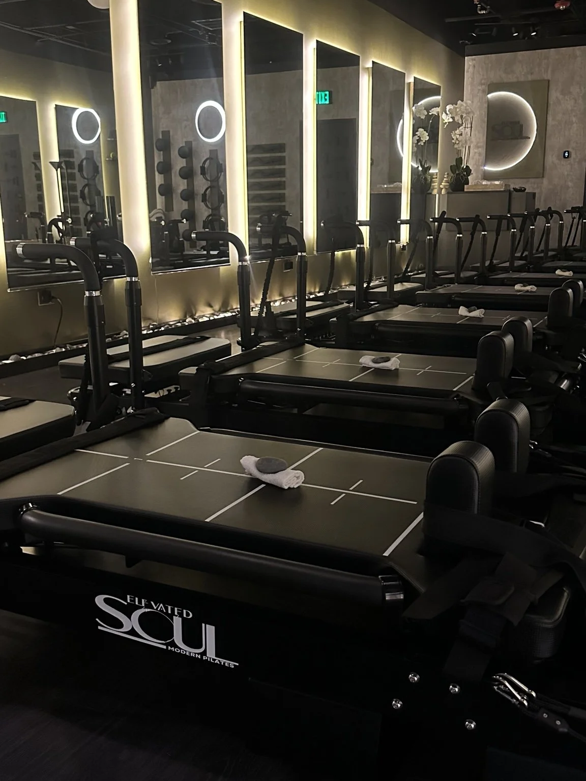 Sculptformer reformers, illuminated mirrors, and Elevated Soul branding inside our Glen Ellyn studio