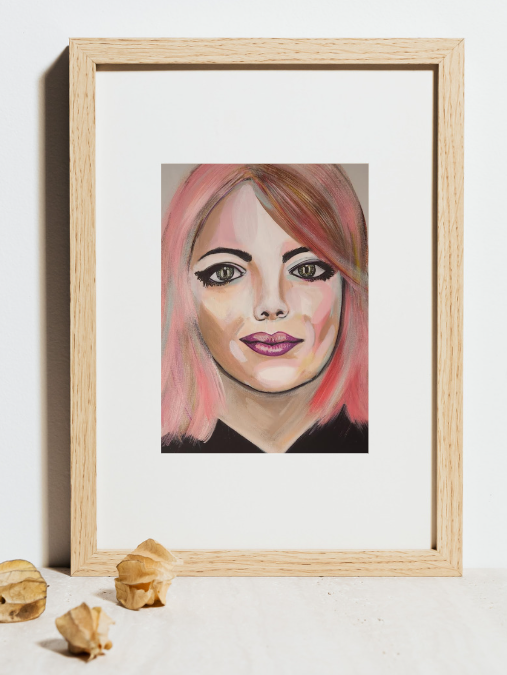 Lady pink hair starting intently slightly smiling