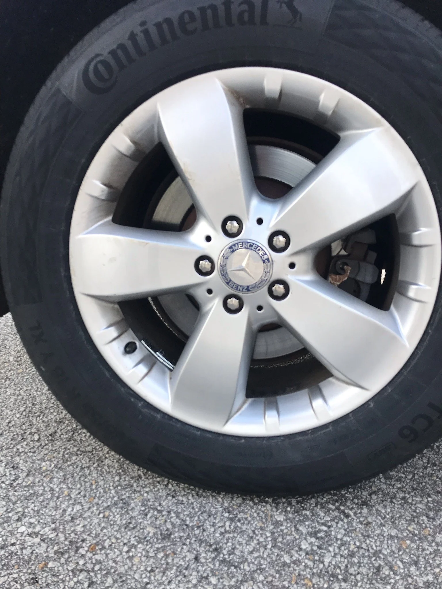 Close-up of a Mercedes-Benz wheel and tire, with a silver alloy rim and black rubber tire.