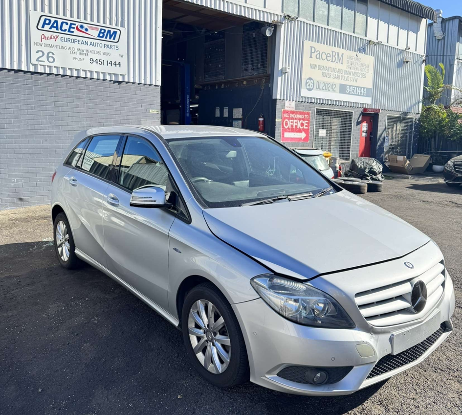 Silver Mercedes-Benz hatchback parked outside an auto parts store