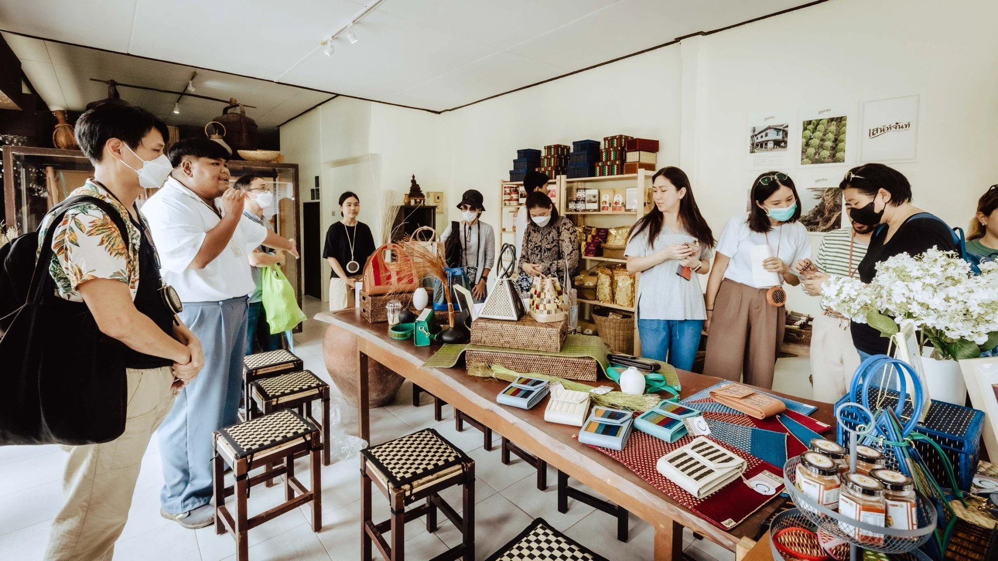 People shopping in a store with various home decor and accessories on display.