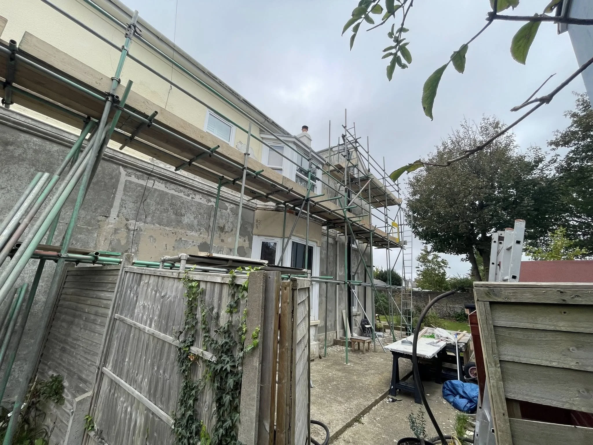 Residential scaffolding erected along the side and rear of a property, providing safe access for exterior renovation, maintenance and building works. West Sussex Coastal Scaffolding Ltd.