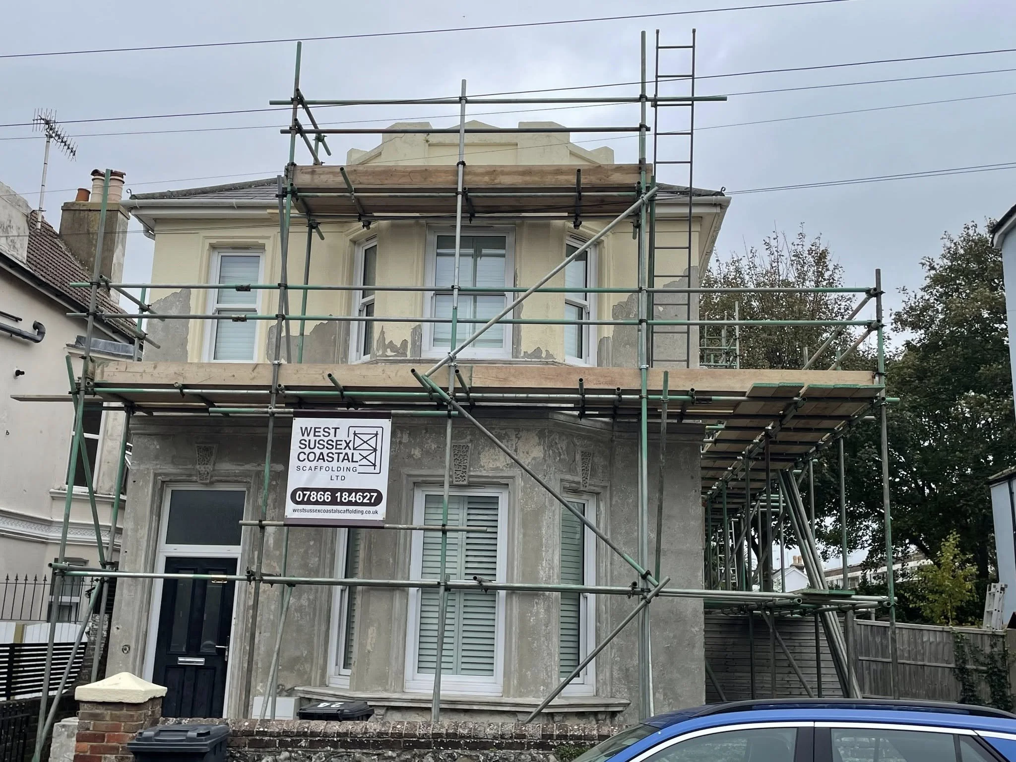 Residential house scaffolding providing safe access to the front, side and roofline for exterior property renovation and maintenance works. West Sussex Coastal Scaffolding Ltd.