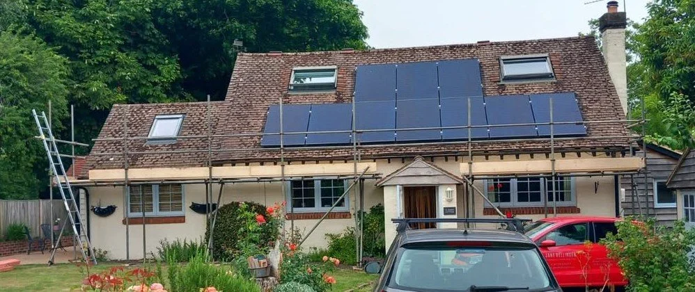 Domestic scaffolding providing safe roof access around solar panels for roofing and property maintenance work. West Sussex Coastal Scaffolding Ltd.