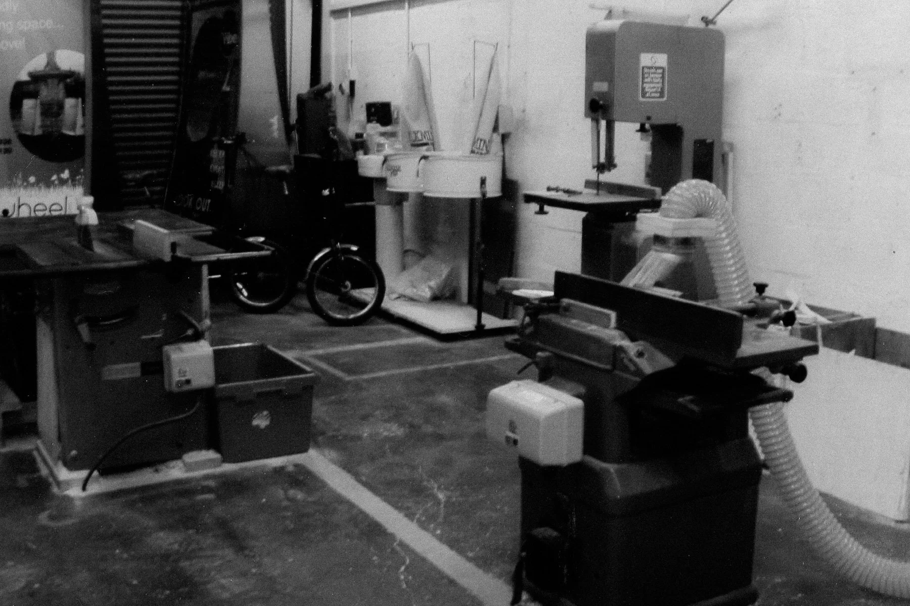 Historic photos of Boomerang Woodworking at it's conception. A black and white photo of machinery in Boomerang Woodworking workshop