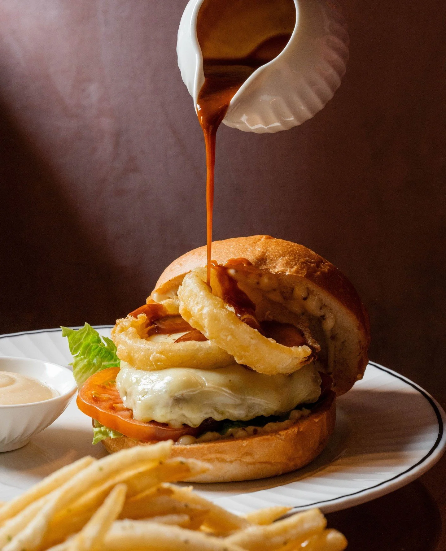 The Ottie&rsquo;s Bistro Burger - 200g dry-aged Angus beef, melted Gruy&egrave;re, peppercorn sauce, crispy onion rings, and shoestring fries on the side. Absolutely stacked and built to impress. 🍔 ⁠
⁠
#DiveBarMelbourne #Burger #MelbourneBars #NeonV