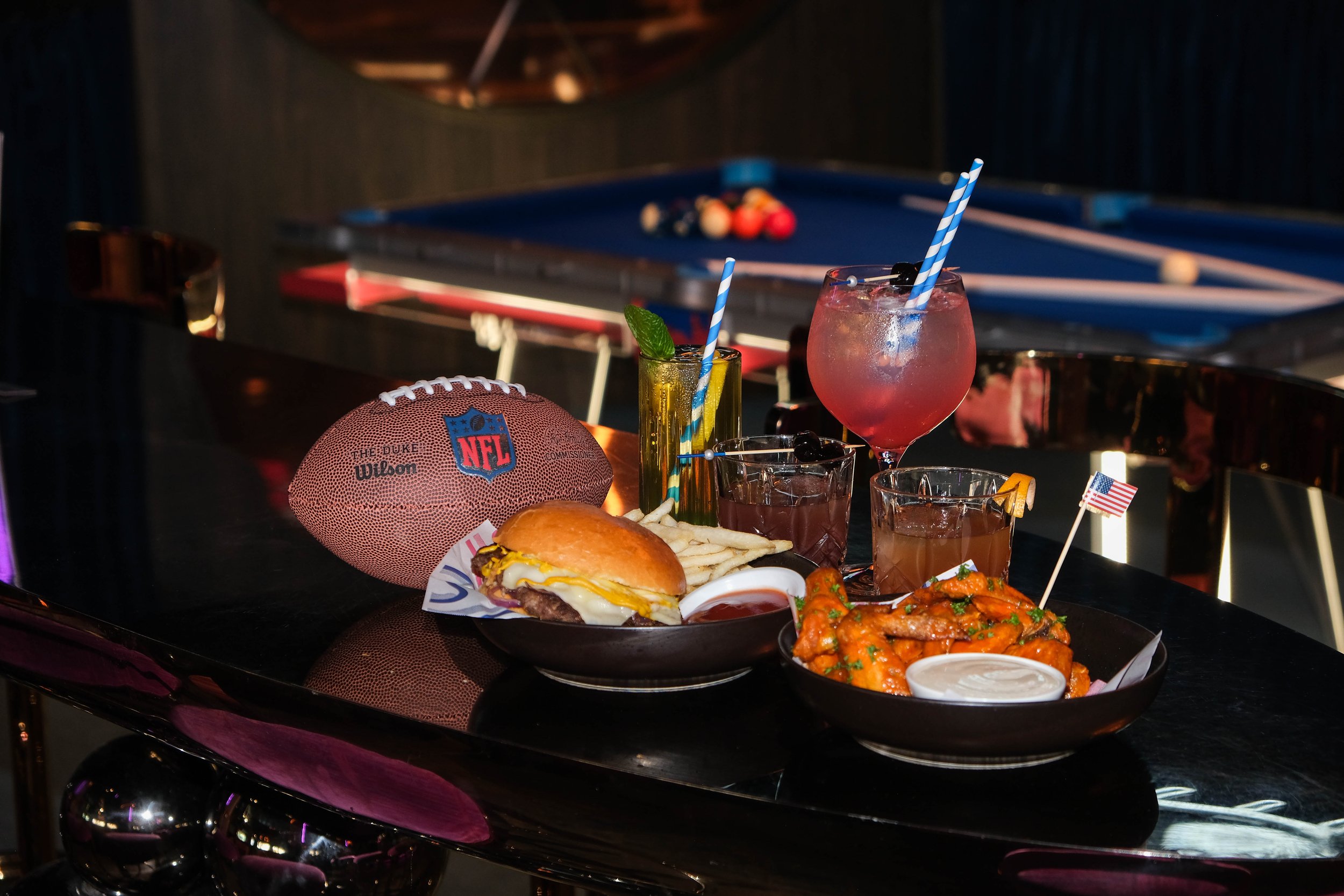 Dive Bar Smash Burger & a basket of Spicy Buffalo Wings on the bar at Dive Bar, Crowne Plaza Melbourne