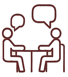 Two people sitting at a table talking with speech bubbles above their heads.