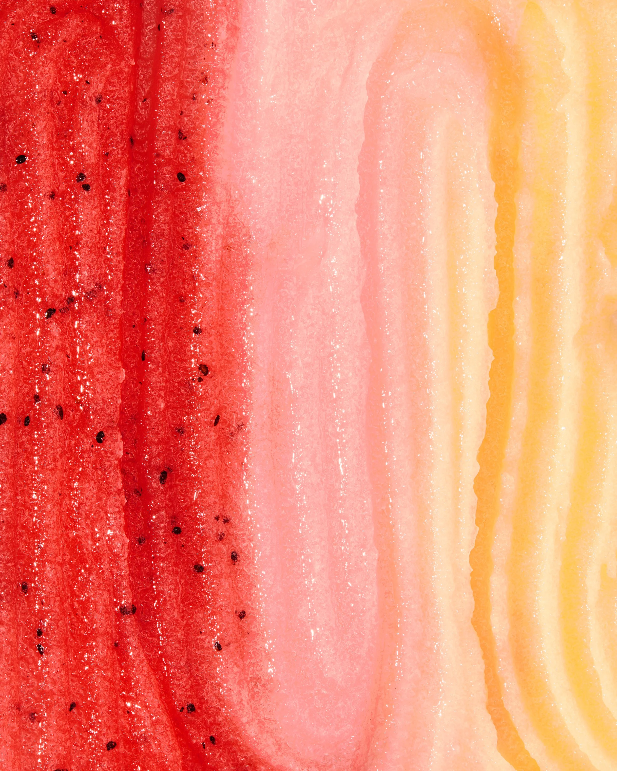 A watercolor painting of watermelon slices with shades of red, pink, and yellow.