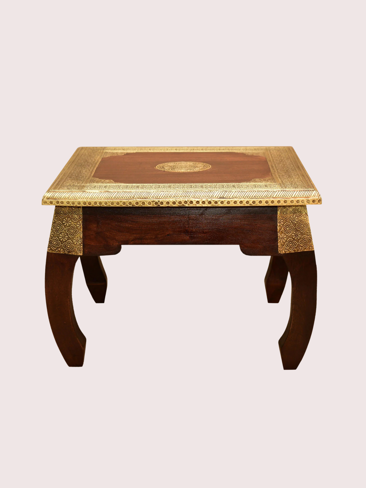 A wooden table with ornate gold detailing on the edges and corners, and intricate gold patterns on the top surface.