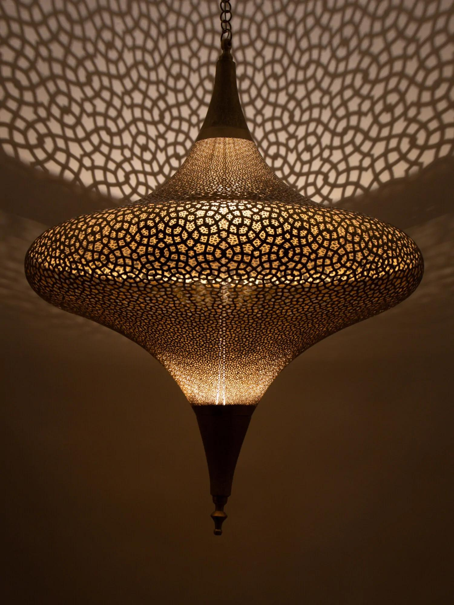  ornate hanging pendant lamp with intricate geometric design casting patterned shadows on the ceiling