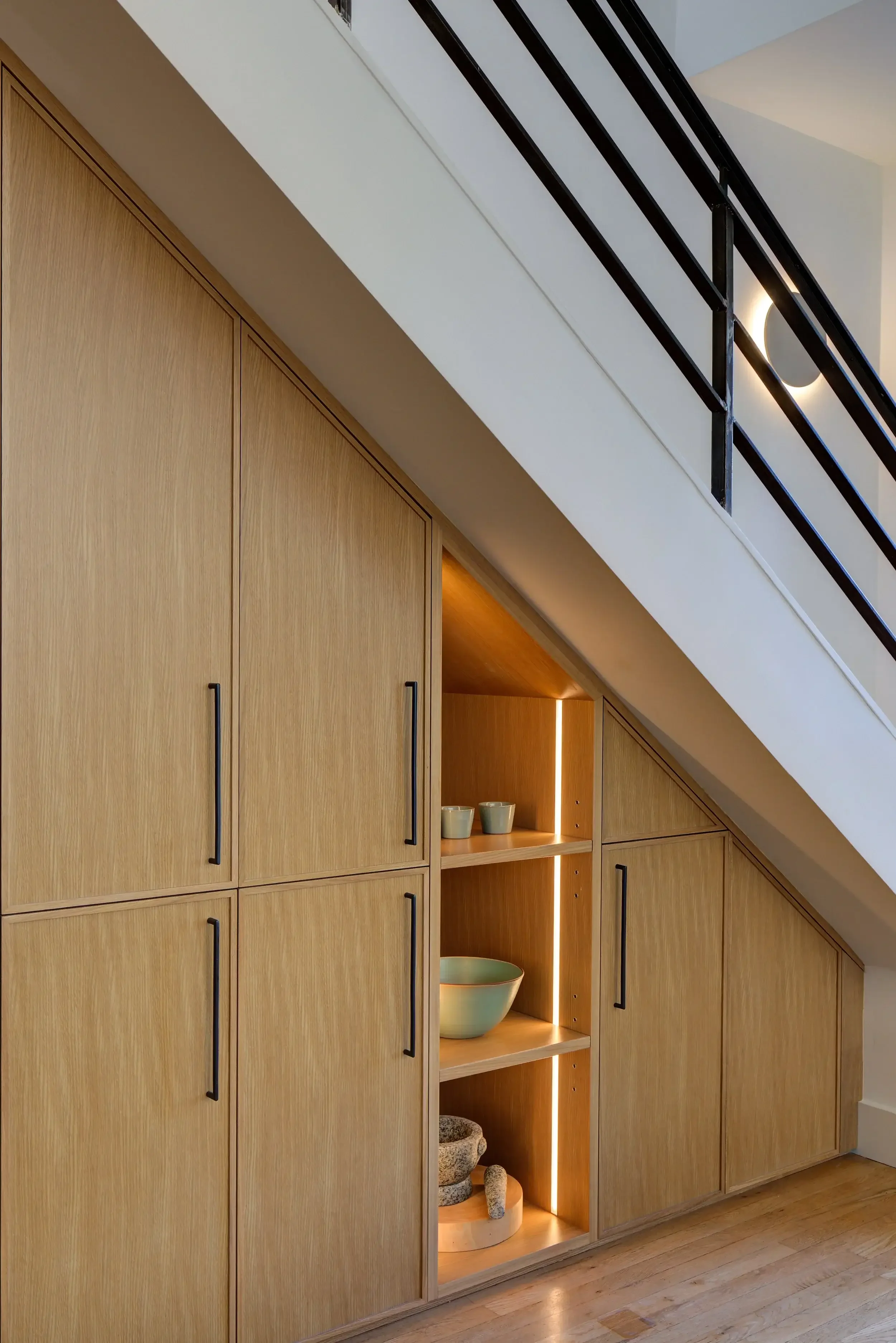 angled-oak-cabinetry-under-stairs.webp