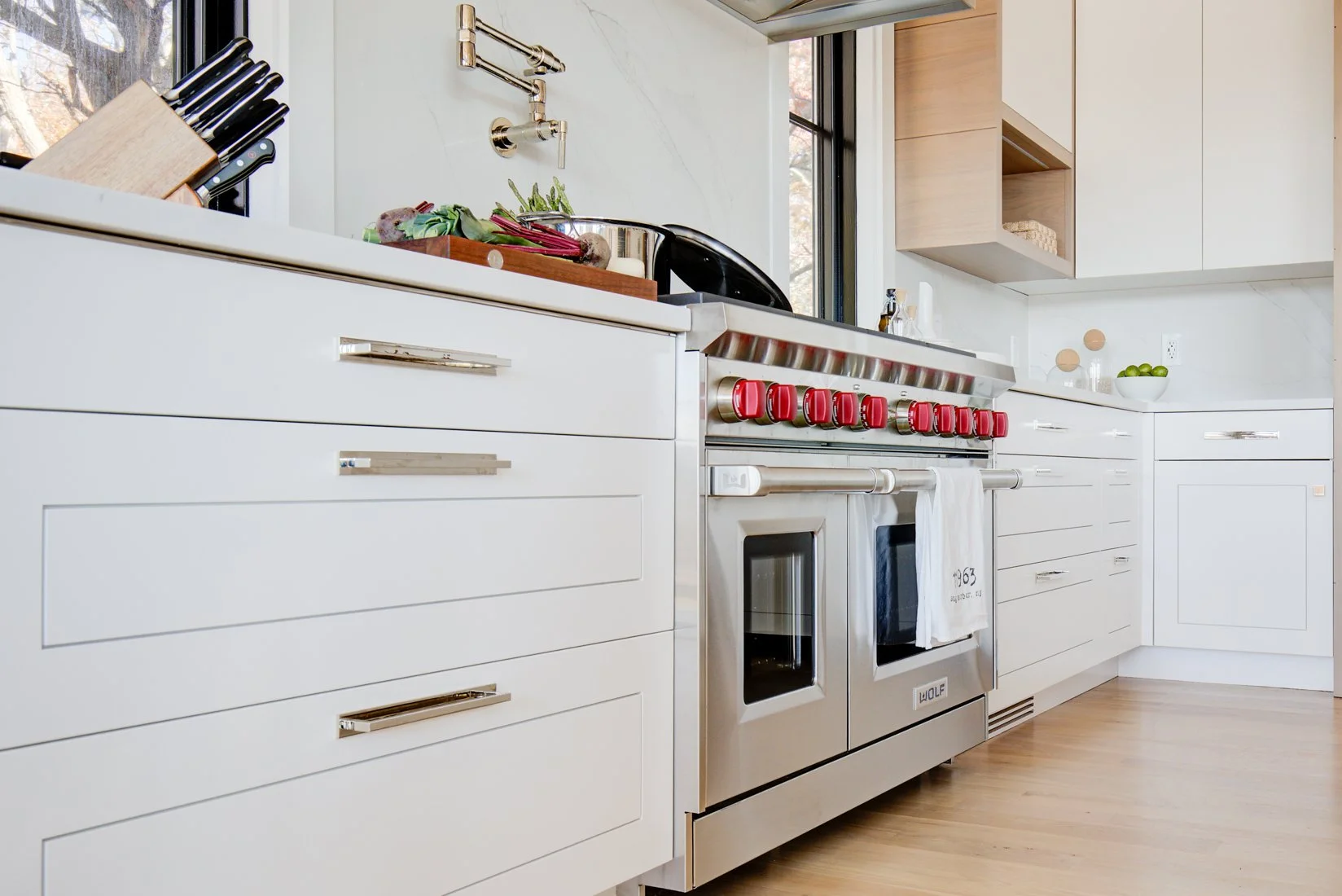 closeup-of-white-revelane-cabinetry-and-wolf-range.jpg