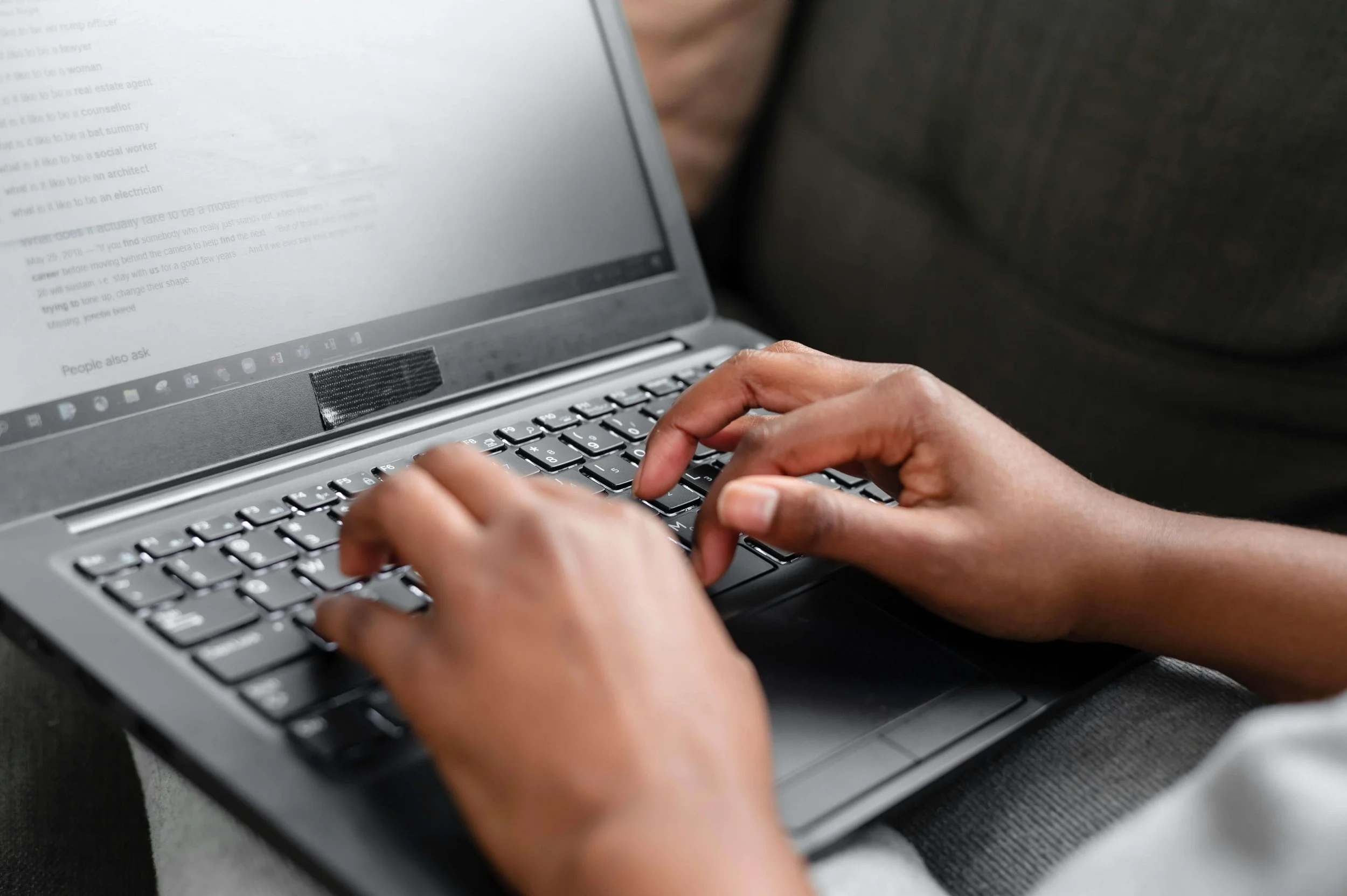 Typing on a laptop keyboard, illustrating communication skill development and structured thinking after completing a communication strengths assessment.