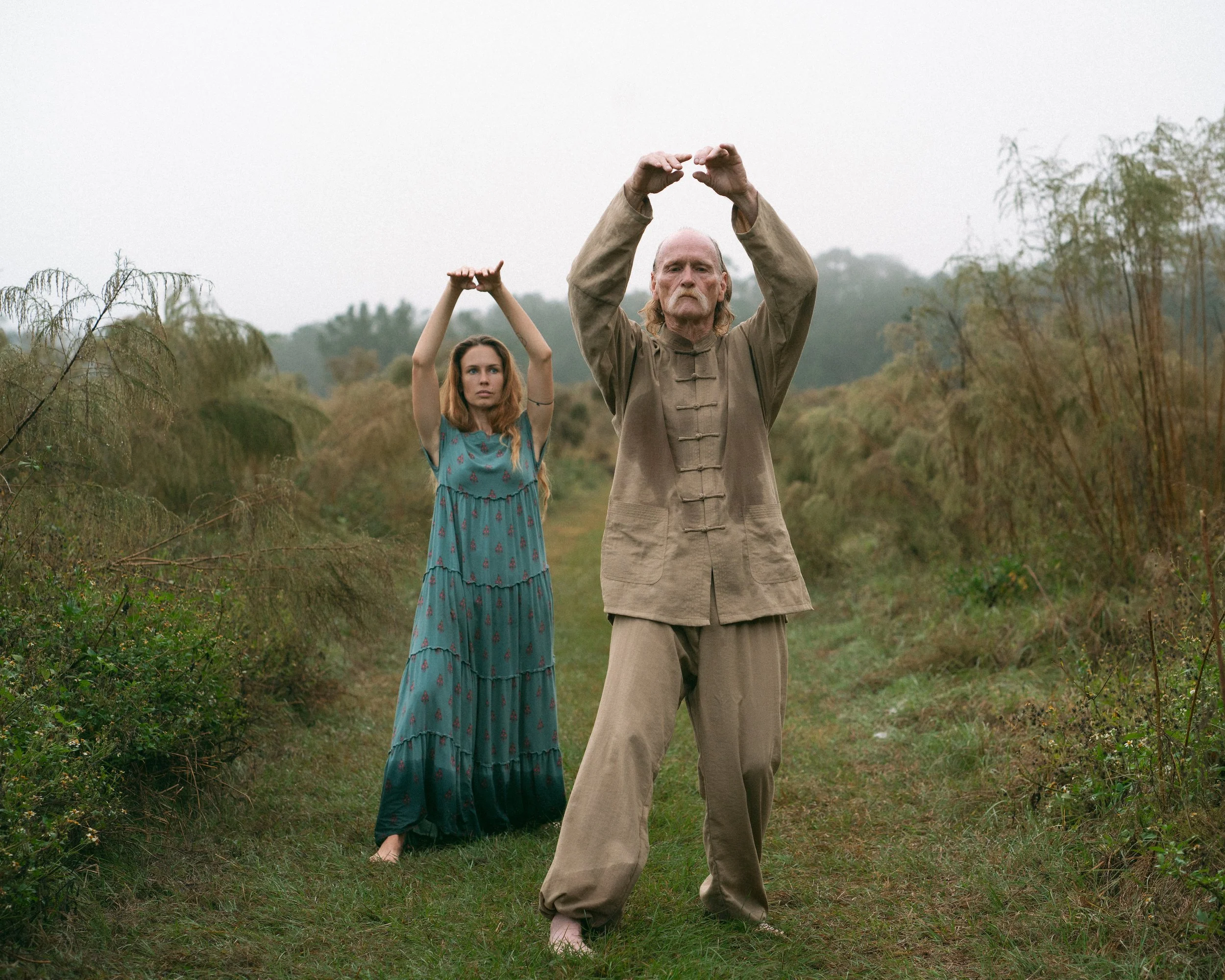 Image of Richard doing Tai Chi with a student practicing behind him