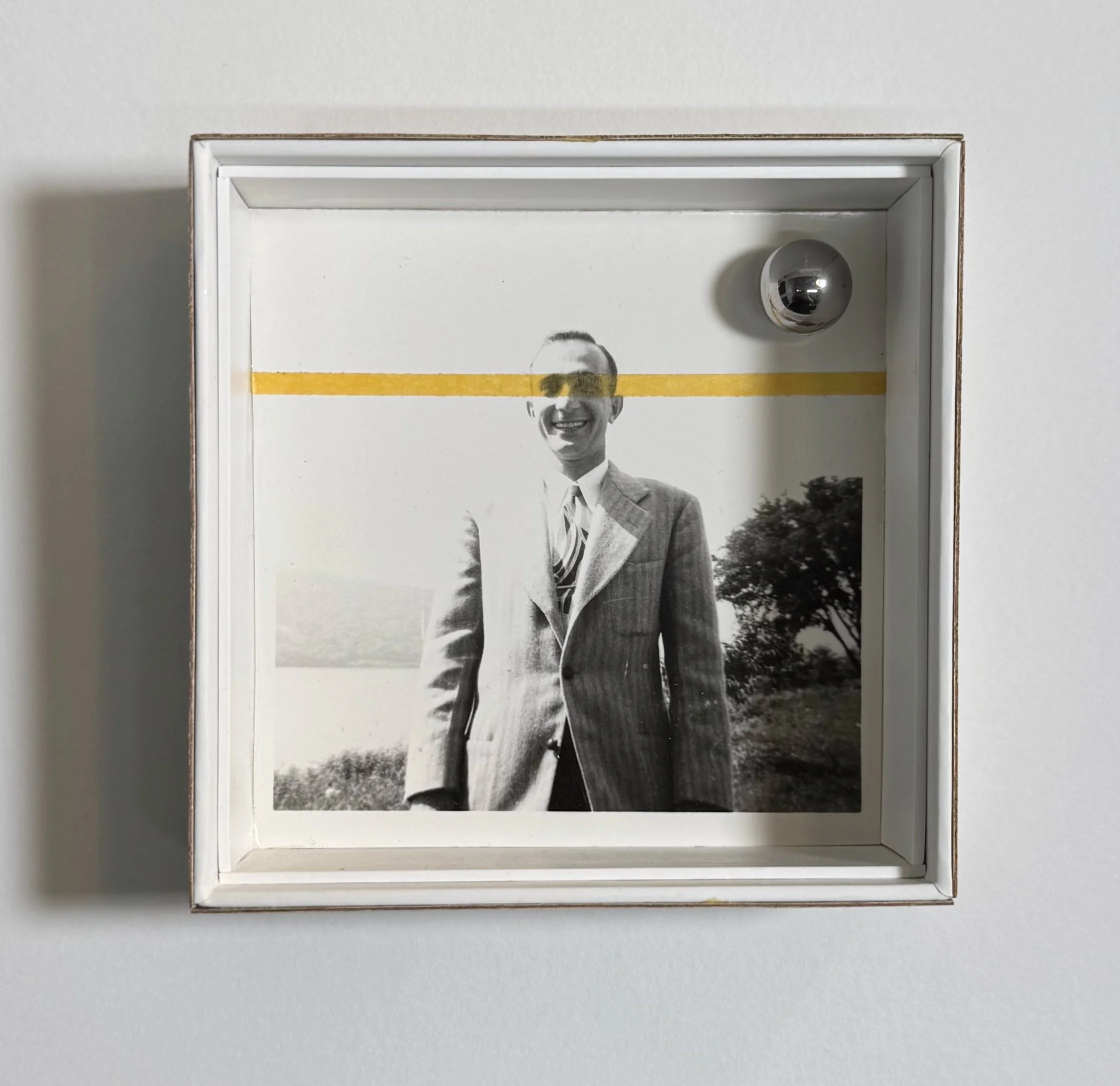 Untitled (Family photos 1), 2024. Found photo, tape, birch veneer, steel ball, magnet, AirPods box, 3.75 x 3.75 x 1.25 inches.