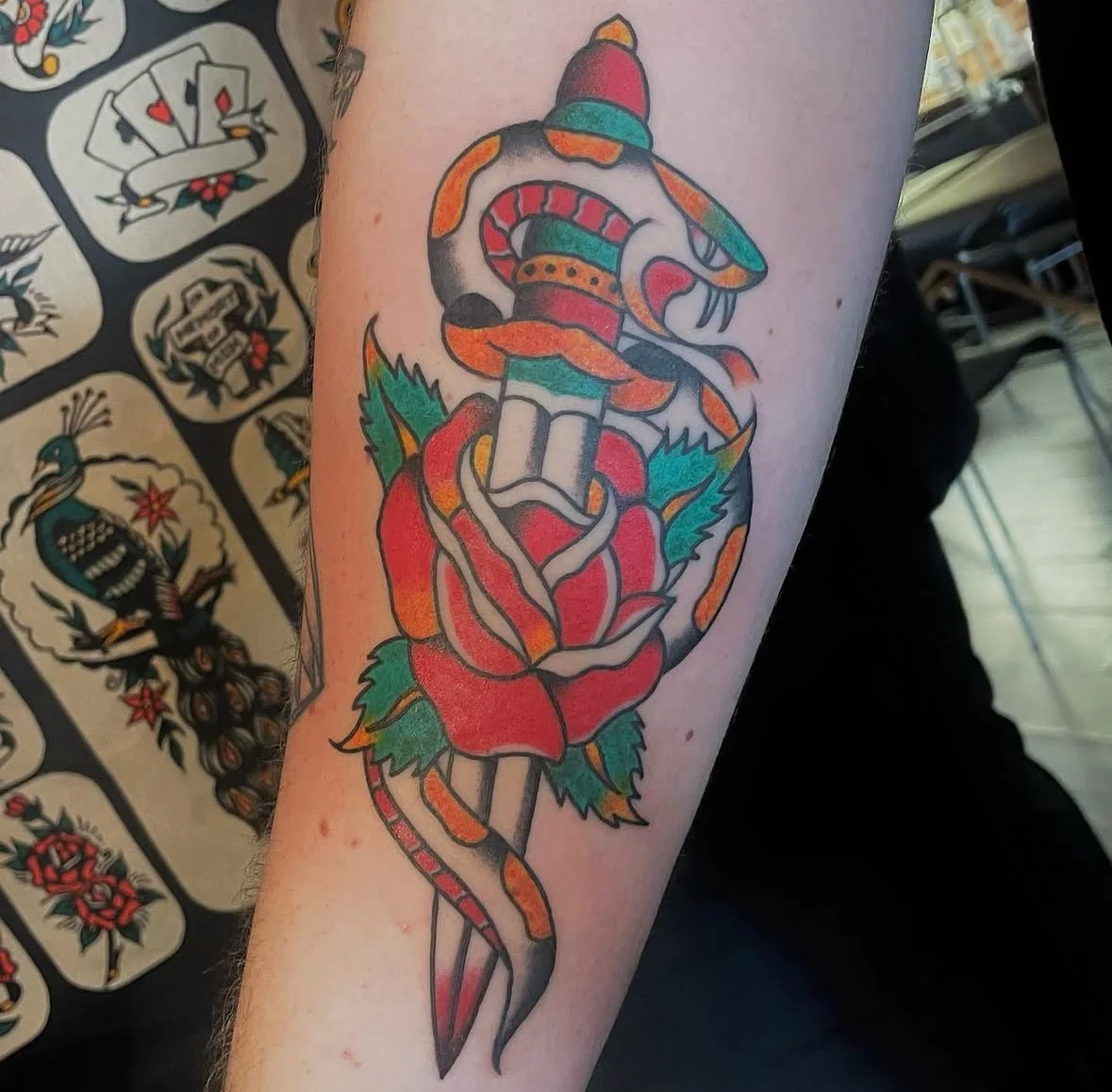 Tattoo of dagger, rose, and snake
