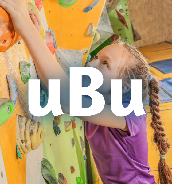child climbing rock wall with text overlay that reads 'uBu'